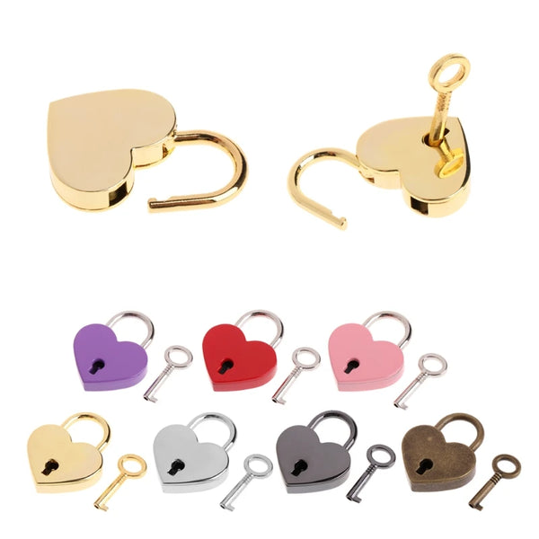 A collection of vintage heart-shaped mini padlocks and keys in gold, purple, red, pink, silver, and bronze finishes.
