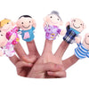 A hand holds a set of plush finger puppets depicting a family of cartoon animals.