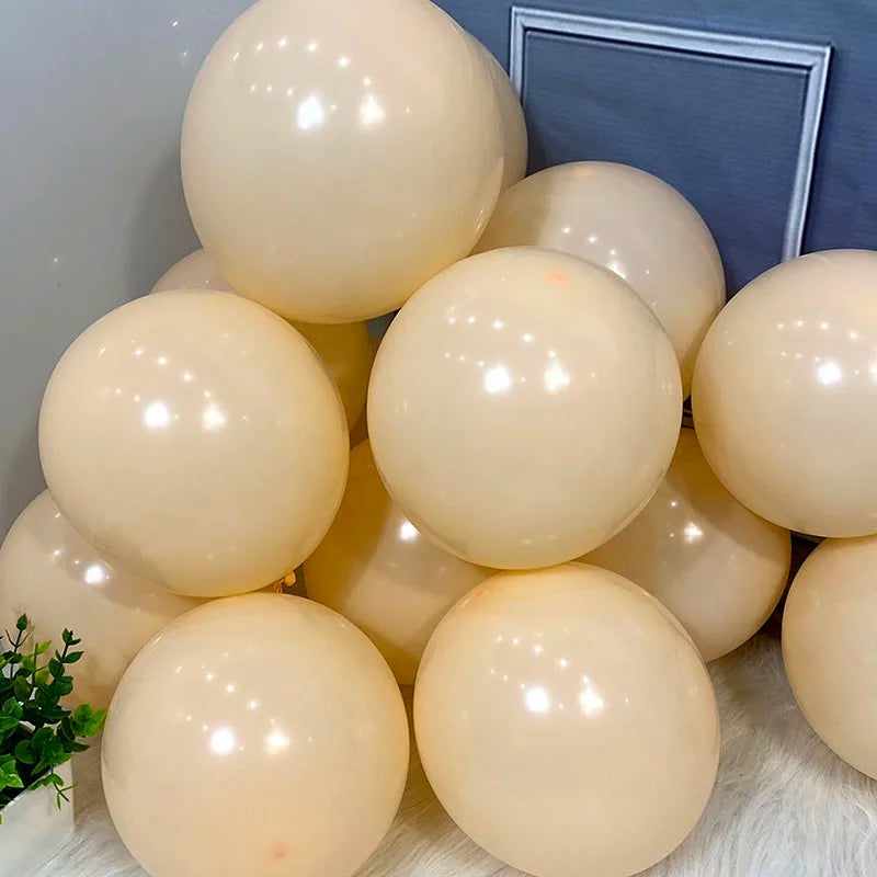A collection of round, pale yellow and cream pastel candy balloons for party decorations.