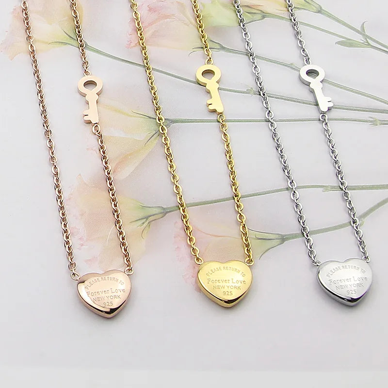 Three gold and silver heart lock key pendant necklaces displayed on a white background.