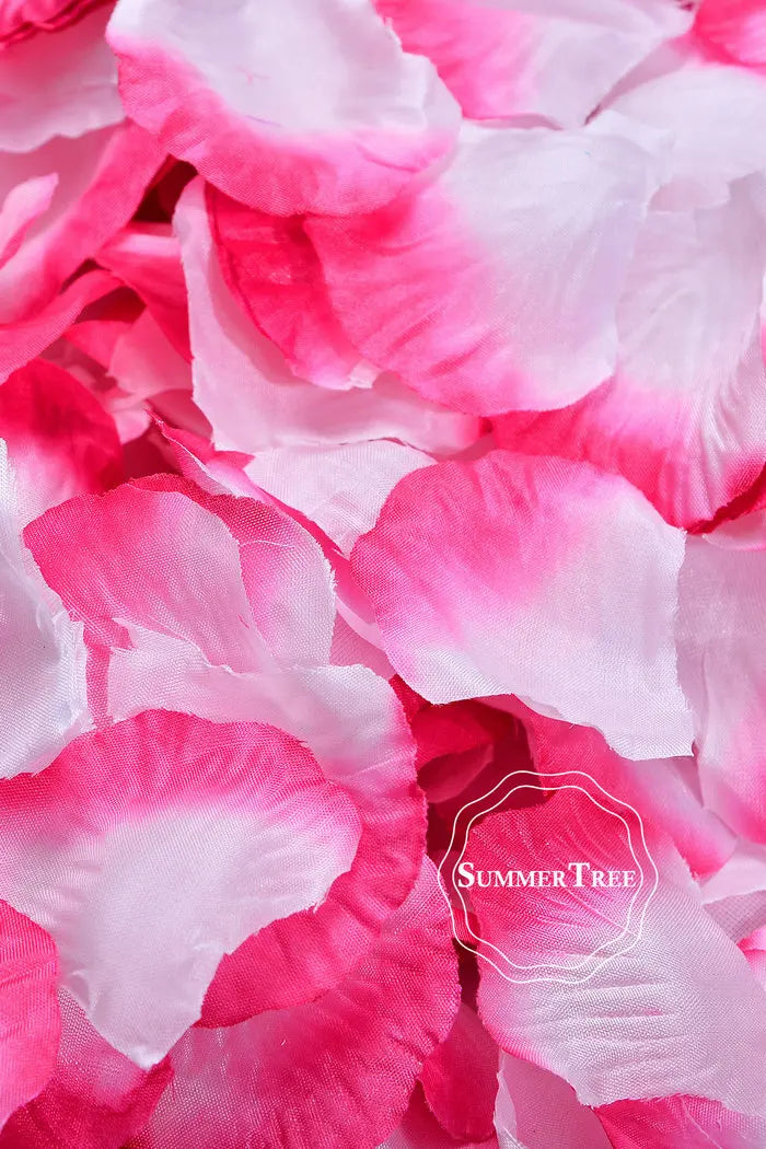 Close-up of vibrant pink and white silk rose petals used for weddings and events.