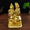 Gold resin figurine of a Hindu or Buddhist deity with long hair and ornate crown sitting in a meditative pose.