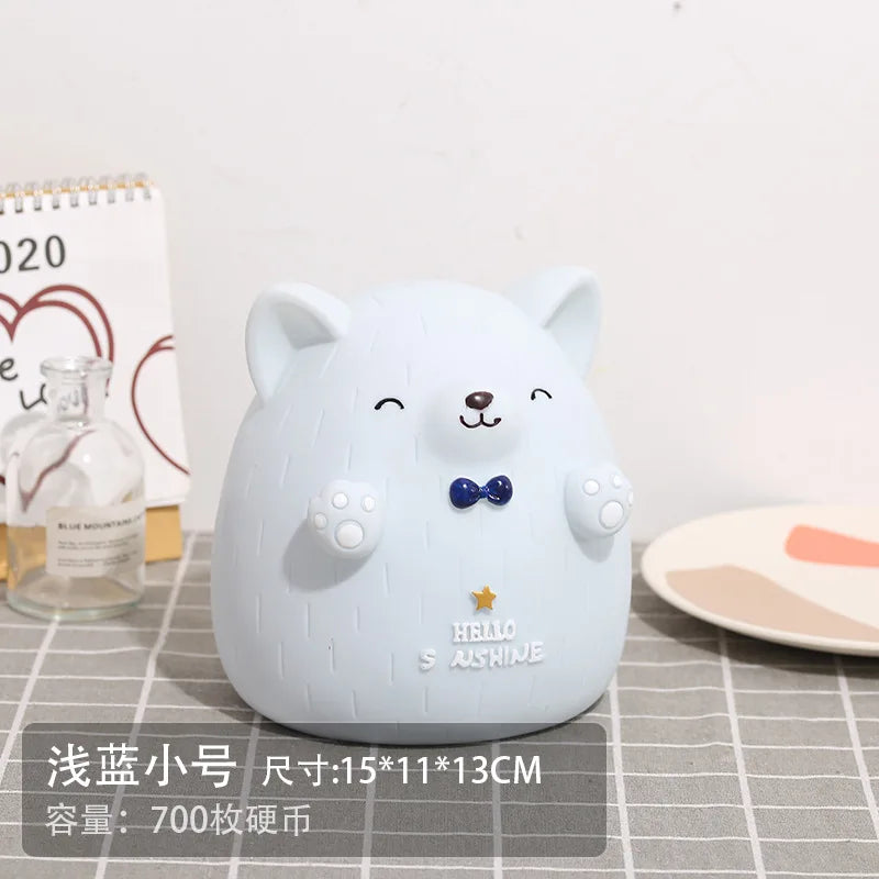 A cute, light blue cartoon pig figure designed as a money saving box or piggy bank.