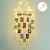 Boho macrame photo display featuring multiple framed photos hanging from a light string