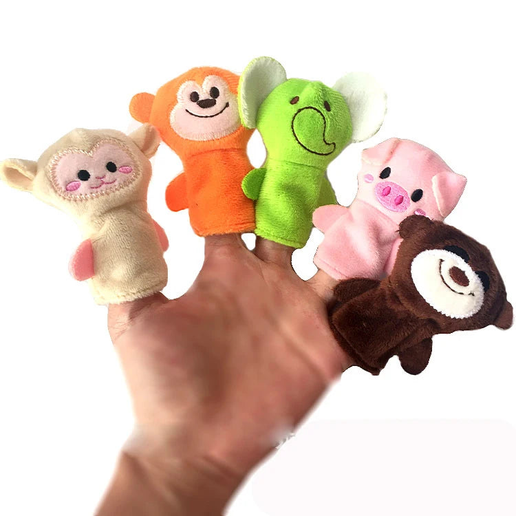 A hand holds a set of plush finger puppets featuring orange, green, and pink animal characters.