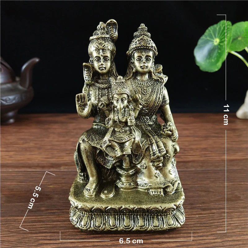 Hand-finished resin Hindu and Buddhist deity figurine of a seated figure in gold color
