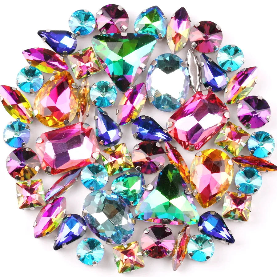 A collection of iridescent glass rhinestones in various colors and shapes set in silver claws.