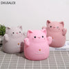 Two pink cartoon cat piggy banks with a smile design placed on a white surface.