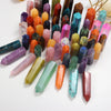 A collection of natural crystal point prisms in various colors and shapes arranged on a white background.