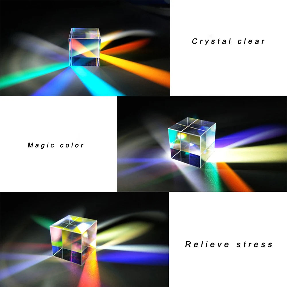 A clear optical glass prism cube is shown refracting light into a rainbow spectrum on a dark surface.