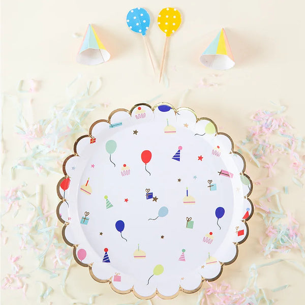 A white paper plate decorated with colorful dots, stars, and small paper party items on a light background.