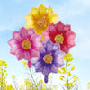 A bouquet of ten heart-shaped foil balloons in shades of yellow, pink, and purple against a blue sky.