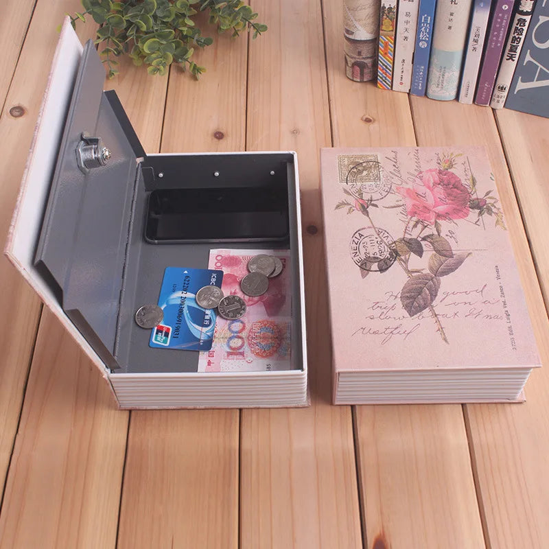 A silver hidden book safe with a combination lock is open, revealing a dark compartment and some currency.
