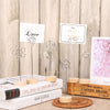 A set of vintage wooden photo frames with metal stands displayed on a wooden surface.