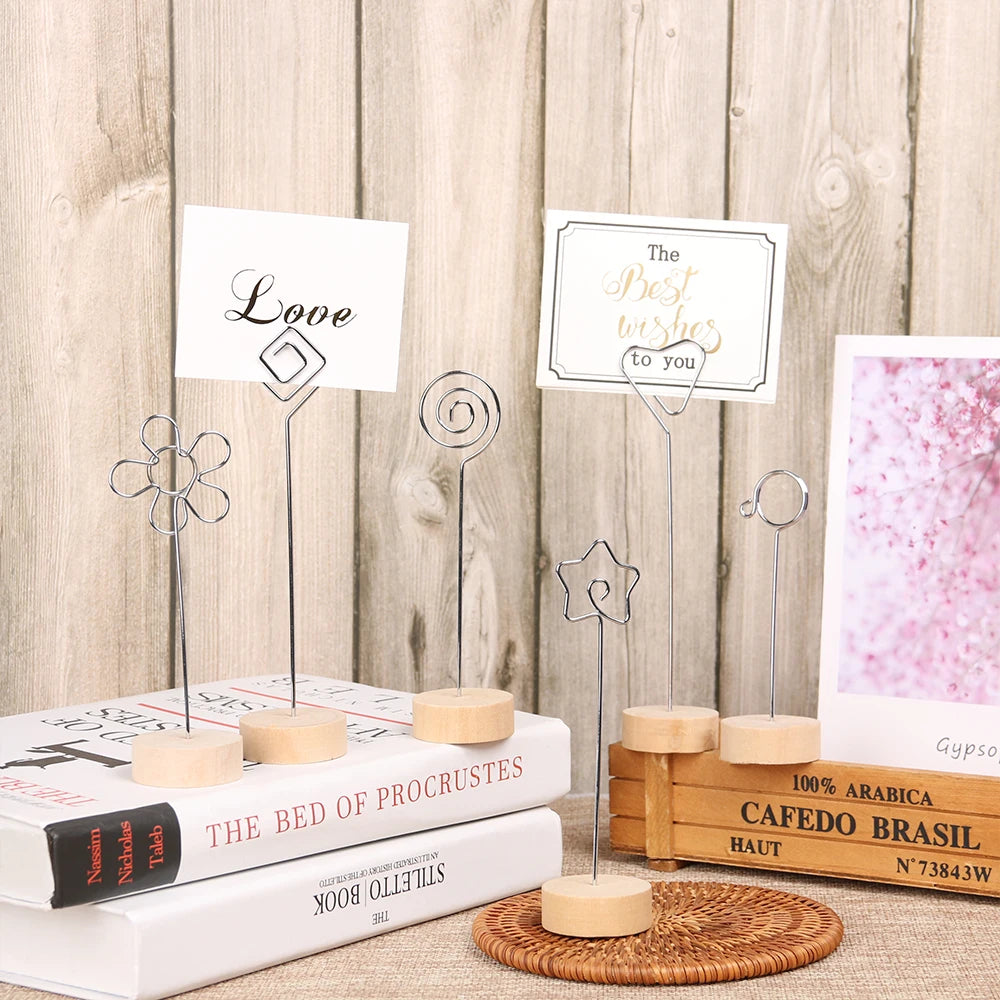 A set of vintage wooden photo frames with metal stands displayed on a wooden surface.