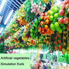 A vibrant display of artificial fruits and vegetables used for decoration or photography.