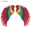 A pair of large sequin wing patches featuring a vibrant rainbow color gradient.