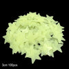 A pile of light yellow glow-in-the-dark star and moon wall stickers.