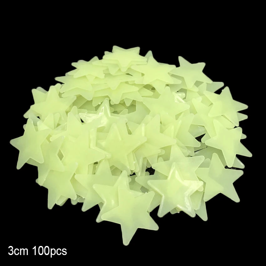 A pile of light yellow glow-in-the-dark star and moon wall stickers.
