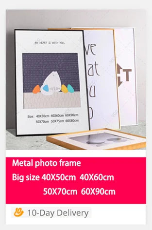 A set of metal photo frames in various sizes displayed on a light surface.