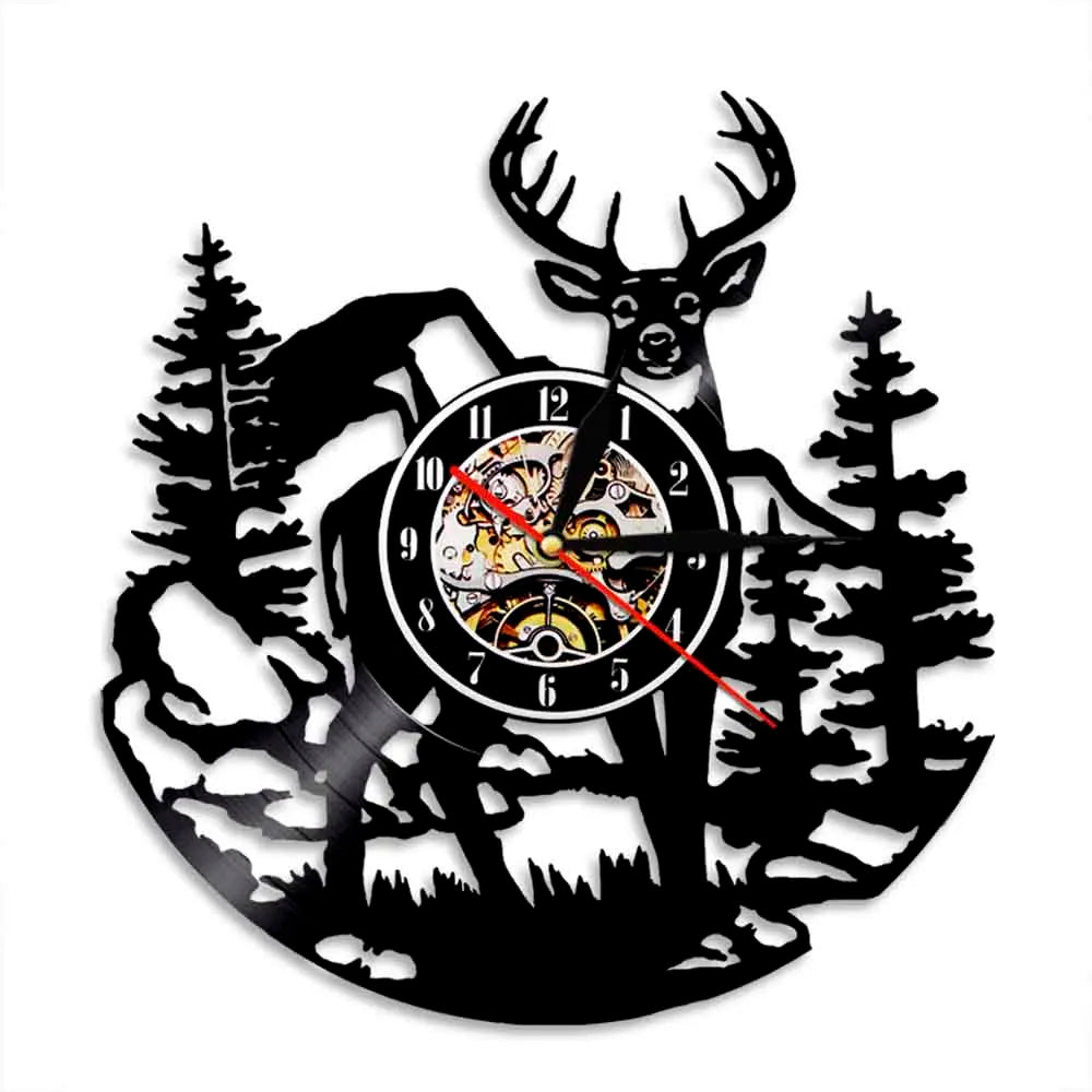 Black silhouette wall clock shaped like a deer head with antlers and woodland trees.