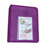 A purple compact photo album for instant film with a window displaying a camera and colorful designs.