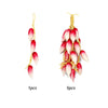 A bundle of five lifelike artificial red and white fruits or vegetables on a thin twine string.