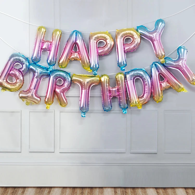 A garland of rose gold and iridescent foil letter balloons spelling out Happy Birthday decoration.