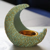 A handcrafted antique crescent incense burner with a textured pale green resin body and gold detailing.