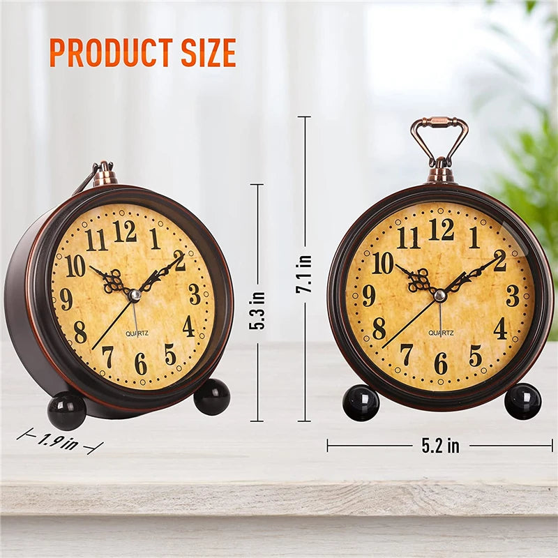 A vintage metal battery alarm clock with a brass-colored face and dark casing is shown next to its size measurements.