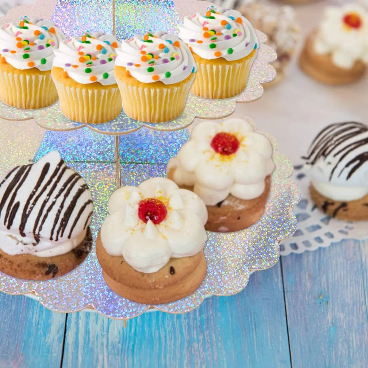 A 3-tier cardboard cupcake stand decorated with colorful frosted cupcakes and chocolate-dipped treats.