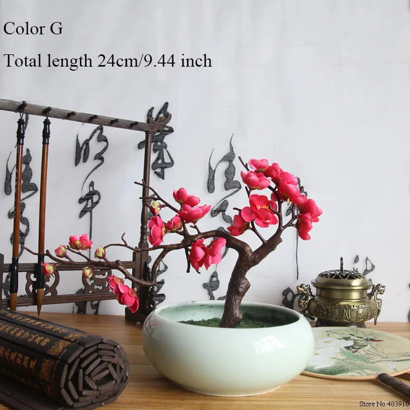 Artificial silk cherry blossom branches in Color G displayed in a white bowl on a wooden surface.