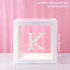 A white transparent box with a letter K inside, used for birthday and baby shower decorations.