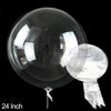 A clear PVC party balloon is shown against a black background, with a small piece of the material dangling below.