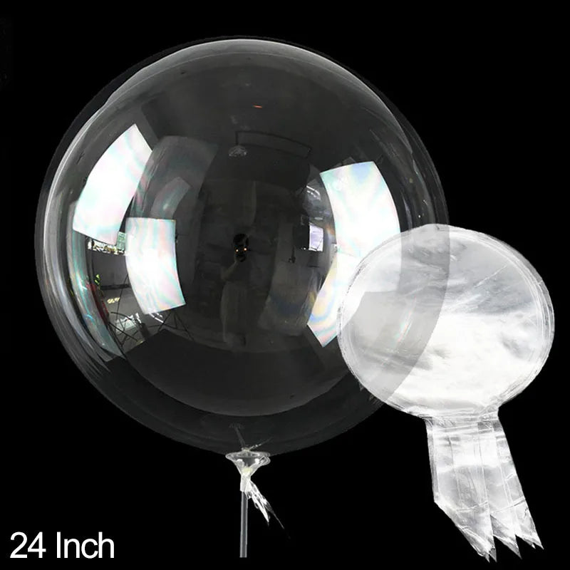 A clear PVC party balloon is shown against a black background, with a small piece of the material dangling below.