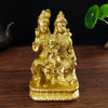 Gold-colored resin figurine of a Hindu or Buddhist deity with a child seated on its lap