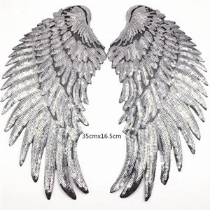 A pair of large silver sequin wing patches for DIY sew-on or iron-on embellishment.