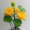 Artificial lotus flower bunch featuring yellow blooms and green leaves with an accent of a small green frog.