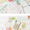 A collection of decorative paper, including memo pads and cards in various patterns and colors.