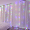 White sheer curtains illuminated by warm white LED string lights in a room setting