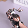 A close-up of a handcrafted metal motorcycle model featuring vintage diecast display pieces.