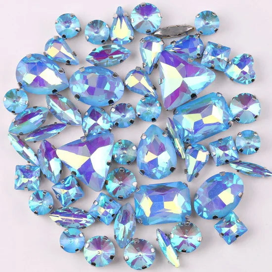 A mix of iridescent blue and purple glass rhinestones set in silver claws.