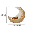 A golden antique crescent shaped resin incense burner with a textured surface.