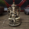 Handcrafted gold resin statue of Lord Ganesha with an elephant head and ornate crown