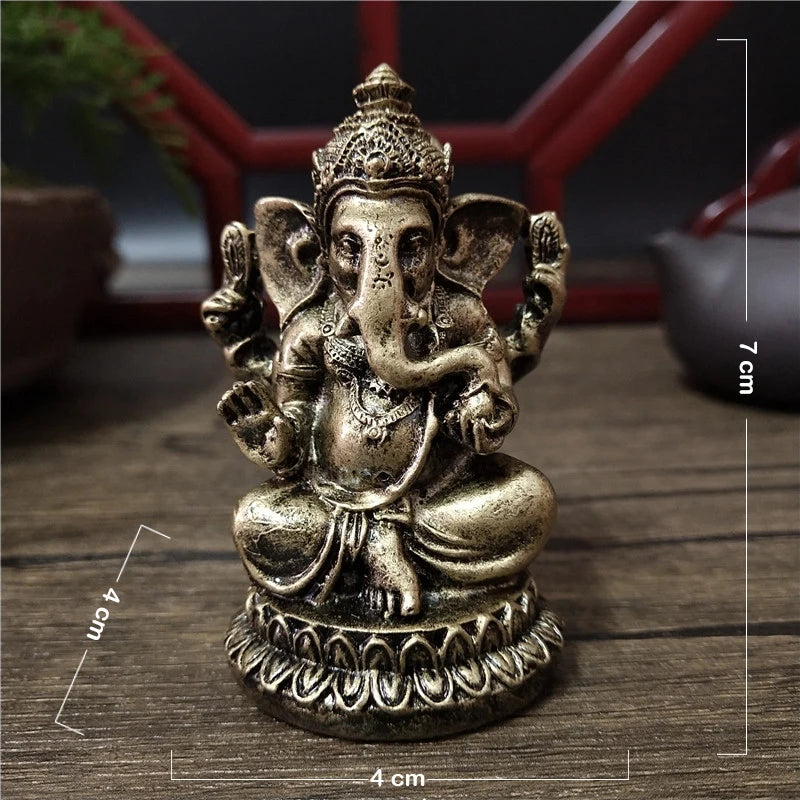 Handcrafted gold resin statue of Lord Ganesha with an elephant head and ornate crown