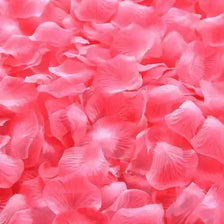 A close-up of vibrant pink silk rose petals used for weddings and events.