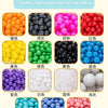 A display of various colorful and clear plastic balls including orange, black, pink, red, blue, yellow, green, purple, white,