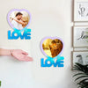 A wall display featuring two heart-shaped silicone molds with photos inside and the word LOVE below them.