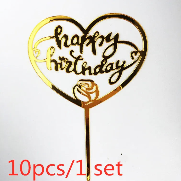 Gold acrylic heart-shaped birthday topper with handwritten text and a rose detail