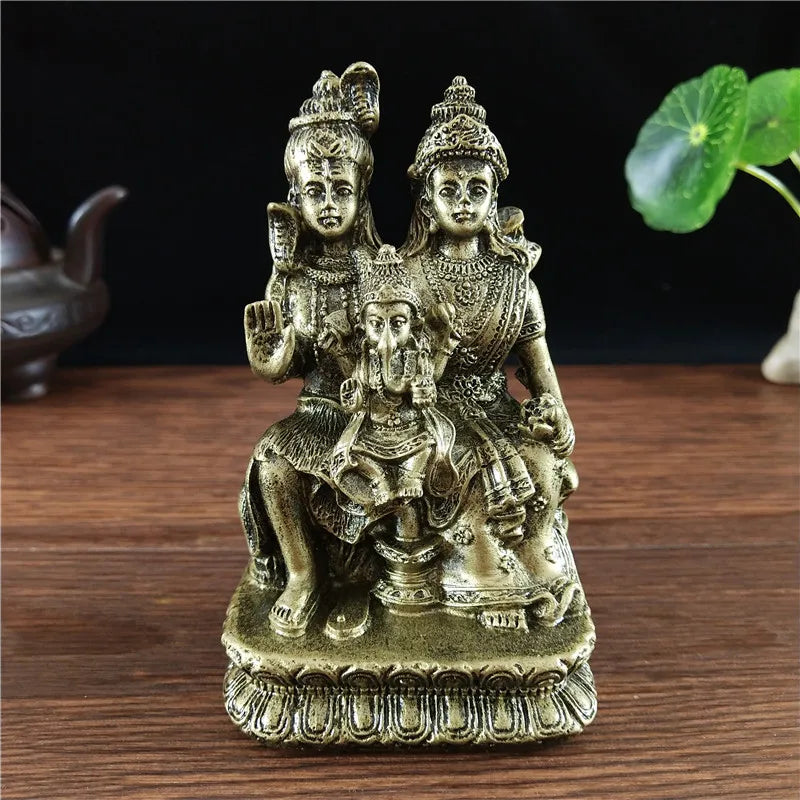 Hand-finished resin figurine of a Hindu or Buddhist deity with a child seated on a pedestal